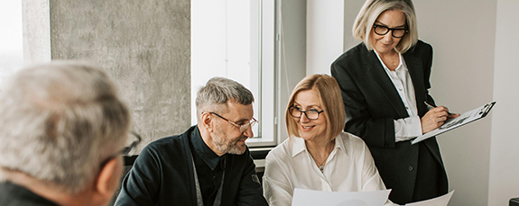 Colleagues reviewing documents at a meeting table